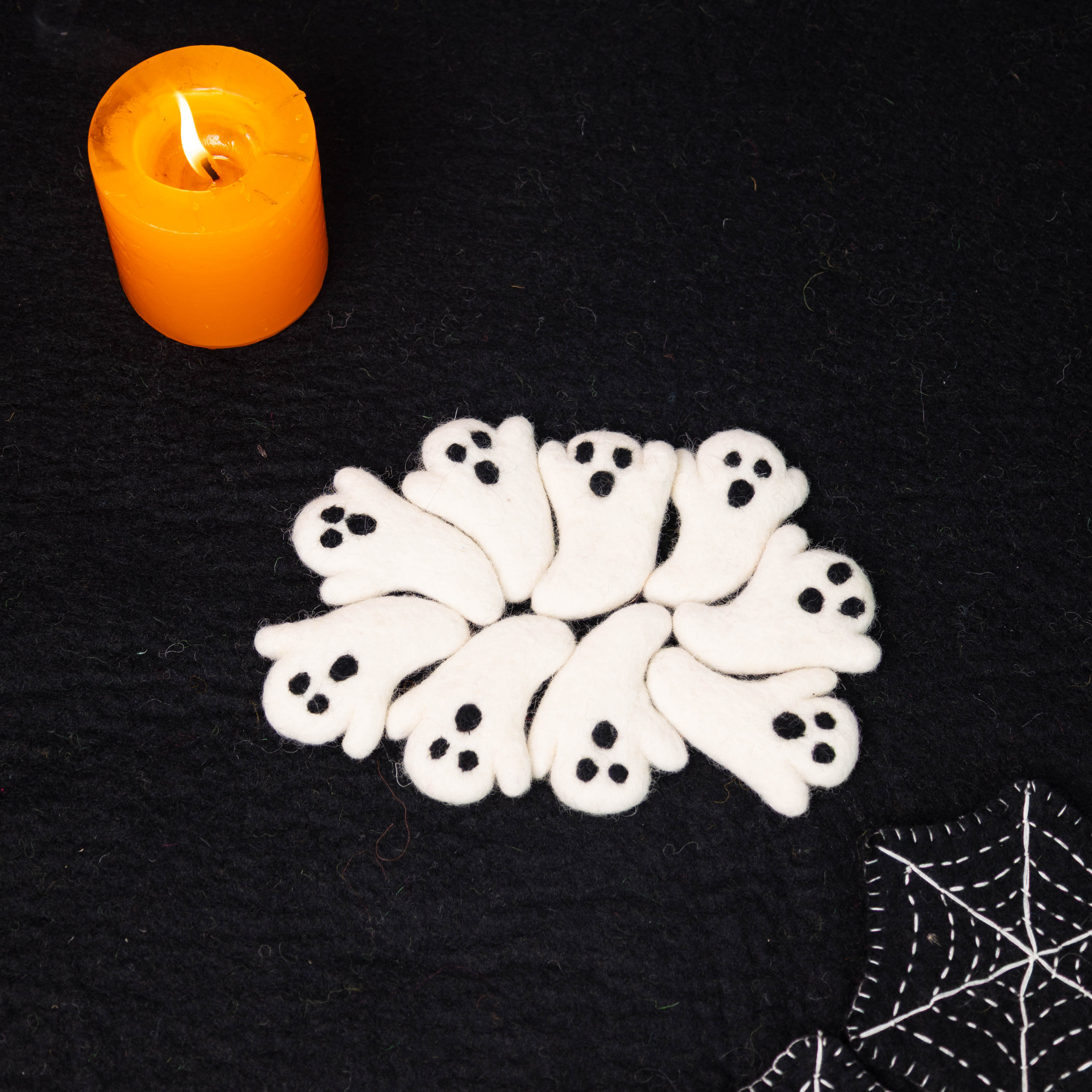 Felt Halloween decorations including ghosts for seasonal retail collections.